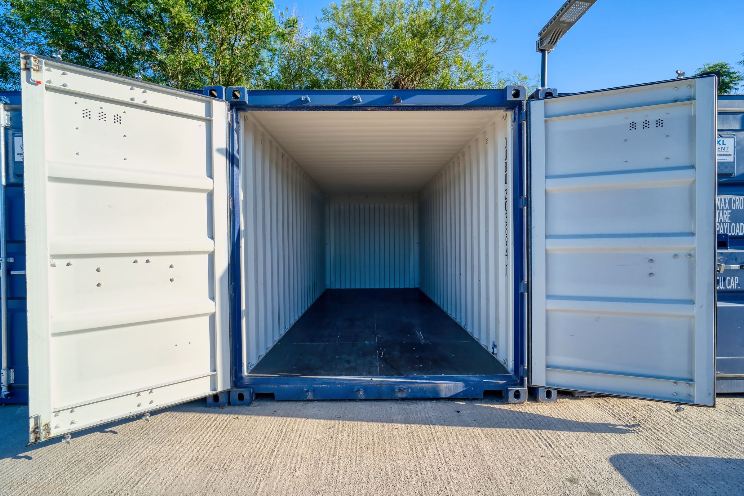 Open empty storage container showing the clean interior and timber floor ready for move-in