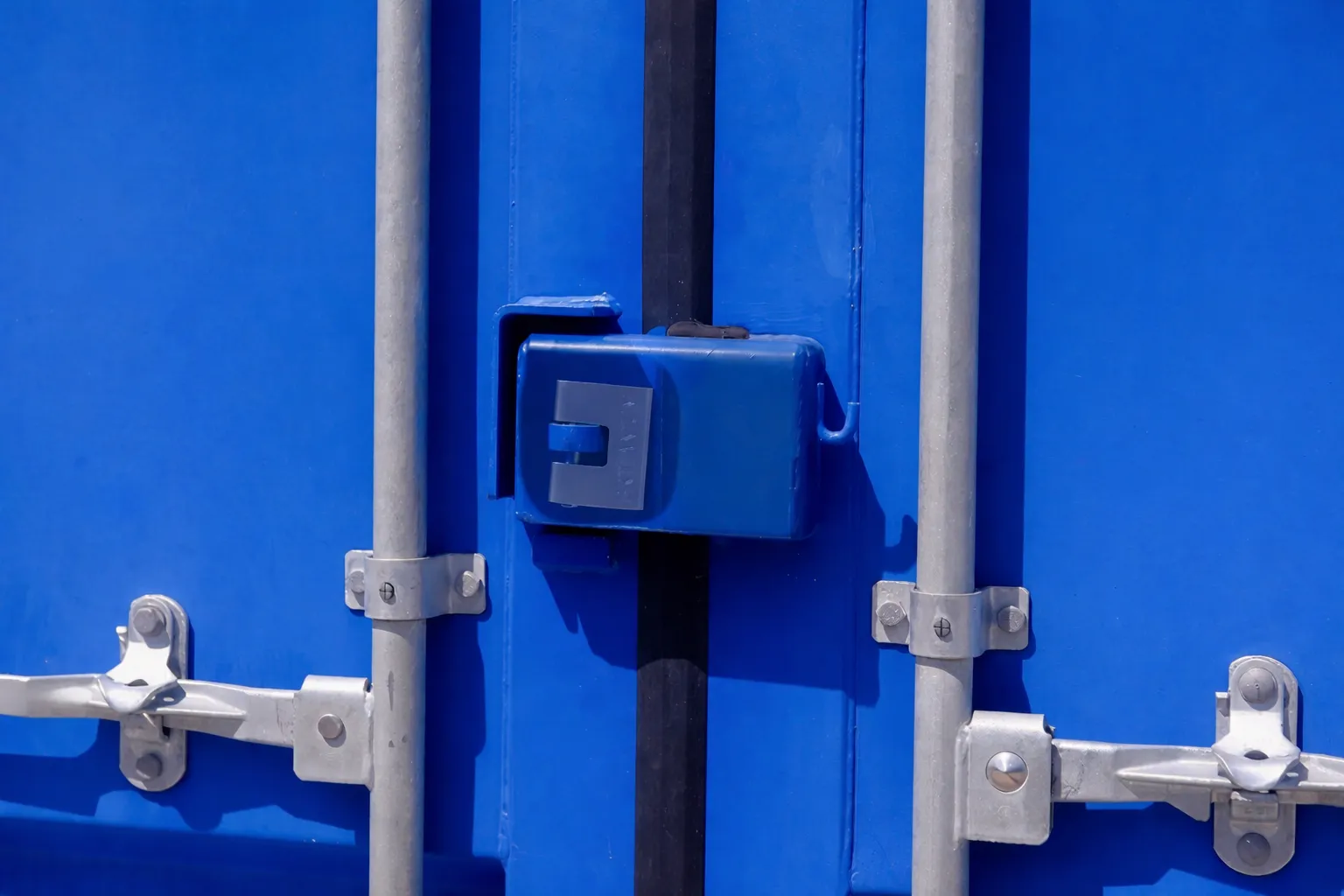 Padlock fitted inside the integrated lock box on a container door.